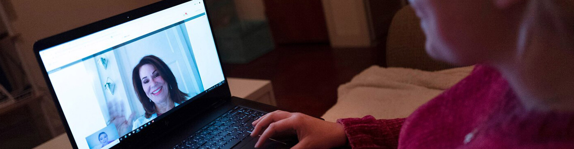 Business on top, pajamas underneath blog banner featuring woman having a video call with coworker