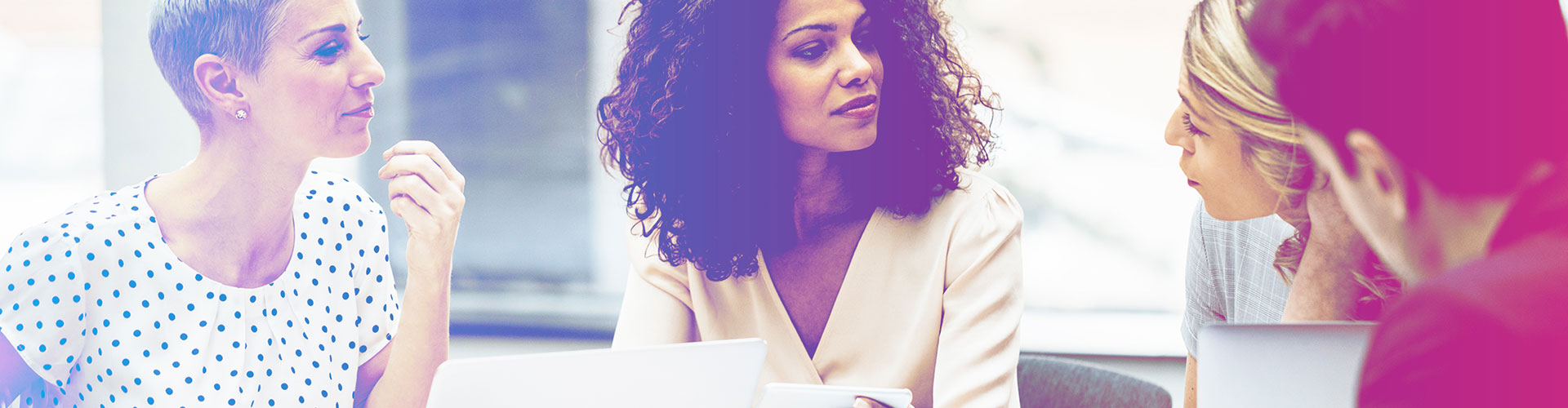 How To Be An Advocate: WE Move Forward blog banner featuring table of casual executive women talking to one another