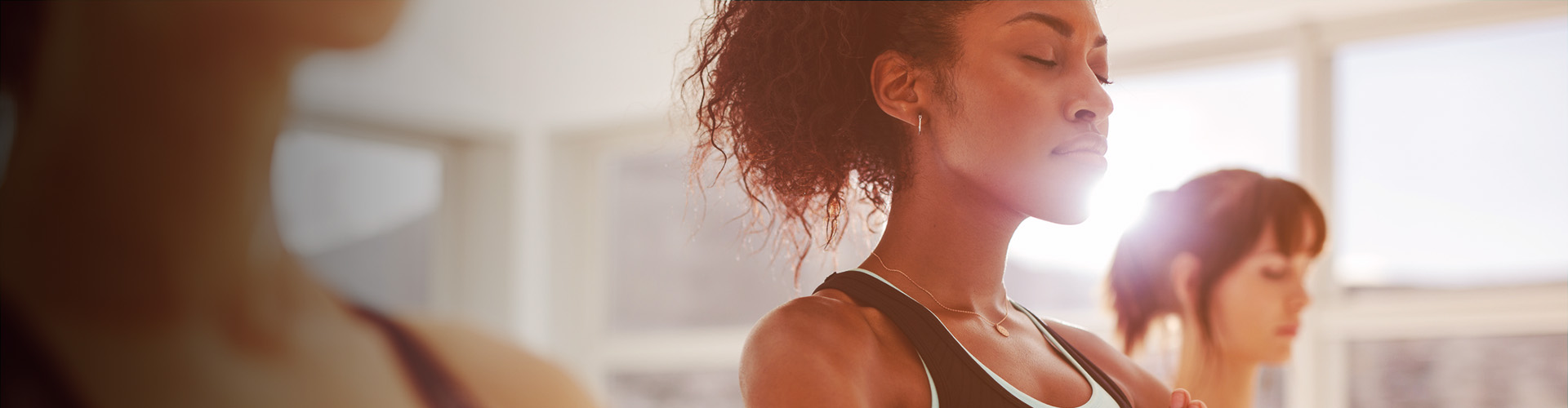 The Big Business of WELL Report Banner featuring three women taking yoga class
