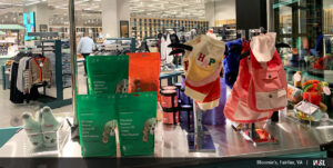 Photo of inside of Bloomie's featuring display cart with dogs clothing and treats